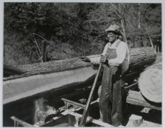 "Curtis Stiner operating circular saw at the Norris Dam site.", 10/26/1933