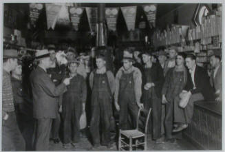 "E. H. Elam, interviewer from the Personnel Division, TVA, conferring with residents of the neighborhood at Stiner's store, Lead Mine Bend, Union County, Tennessee, and explaining the methods of employment used by the TVA.", 11/08/1933
