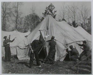 "Setting up a sleeping tent at CCC Camp, TVA #22, near Esco, Tennessee, to accommodate replacements who arrived from New York on November 17, 1933. The nucleus of this camp arrived on October 19, 1933, from Idaho, where they had been working during th