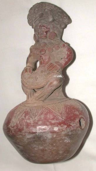 Bottle With Chief Seated On A Stool