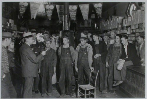 "E. H. Elam, interviewer from the Personnel Division, TVA, conferring with residents of the neighborhood at Stiner's store, Lead Mine Bend, Union County, Tennessee, and explaining the methods of employment used by the TVA.", 11/08/1933