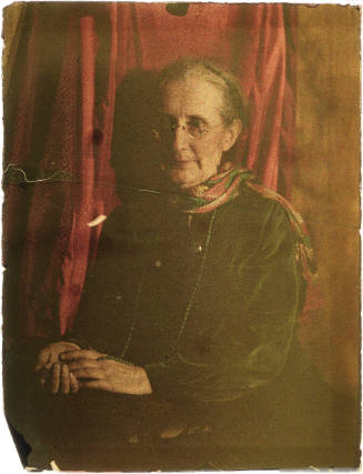Older Woman in Green Dress, Red Background