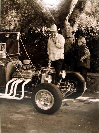 Man and Boy Looking at Vintage Car