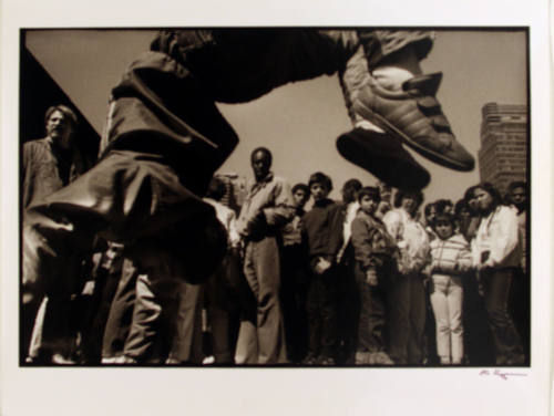 Street dancer executing back flip, New York