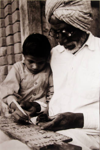 Grandfather sharing the wonder of writing in Gujranwala, Pakistan