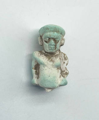 Fragment of an Amulet or Charm Depicting the Head and Torso of the Egyptian God Bes